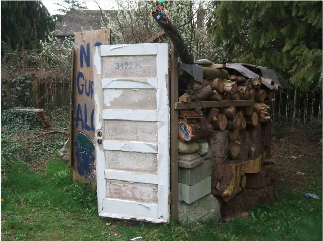 Caroline's runner-up for favourite “house” still standing is 3492 ½ West 35th. It’s a sort of rondavel constructed out of firewood, driftwood, plywood, cinderblocks, tarpaper and stones, with fanciful ornamentation. "I haven’t been inside because, as you can see, no “gurls” are “aloud”. 
