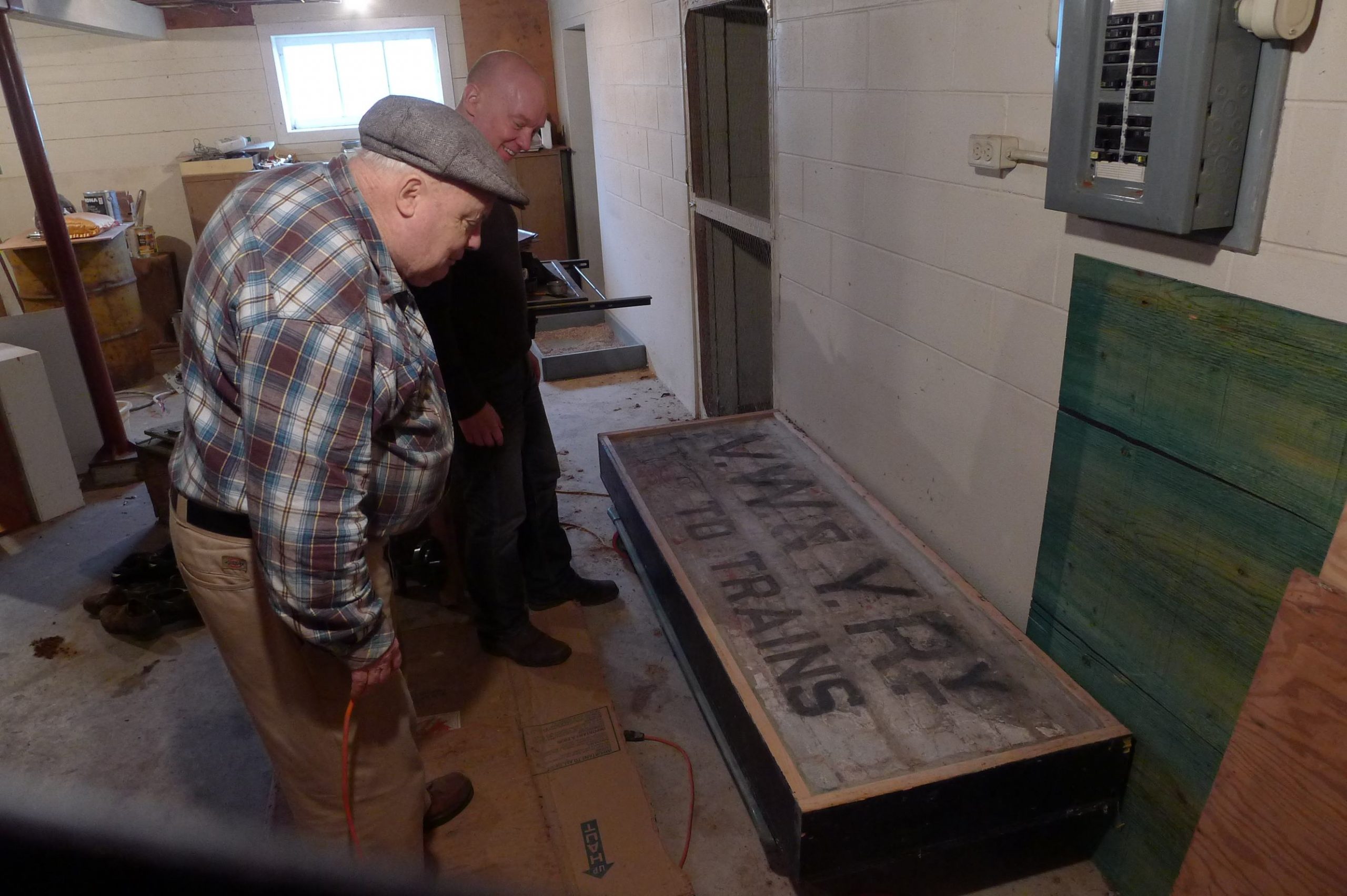 Tom Carter and Arthur Irving with the vintage railway sign in 2012. Andrew Martin photo